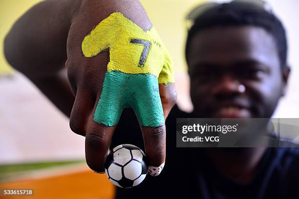 Students use their painted fingers to play kick soccer during a competition at Liaocheng University on May 22, 2016 in Liaocheng, Shandong Province...