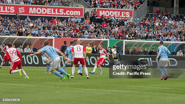 Dax McCarty of Red Bulls controls ball at MLS game NYC FC against Red Bulls at Yankee stadium. Red Bulls won 7-0.