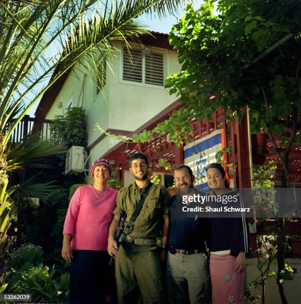 The Ochyoen family, Tzvia , Elyasaf , Yamin and Yirat Ochayen, stands for a portrait in front of their house that they have lived in for the last 20...