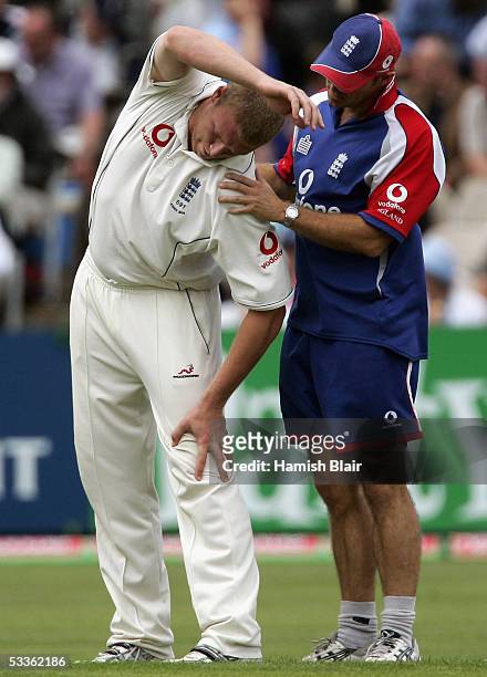 Andrew Flintoff of England receieves treatment from physio Kirk Russell during day two of the Third npower Ashes Test between England and Australia,...
