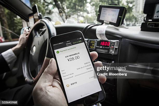 The payment confirmation page is displayed on the Didi Chuxing application in this arranged photograph taken in Shanghai, China, on Sunday, May 22,...