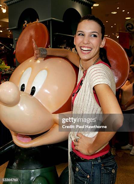 Actress Christy Carlson Romano poses with a 75th Anniversary Mickey Mouse designed by Carlson Romano depicting her alter ego "Kim Possible" as she...