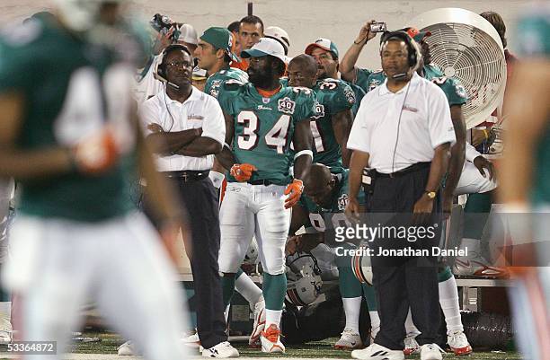 Ricky Williams of the Miami Dolphins stands on the sideline against the Chicago Bears during the NFL Hall of Fame pre-season game at Fawcett Stadium...