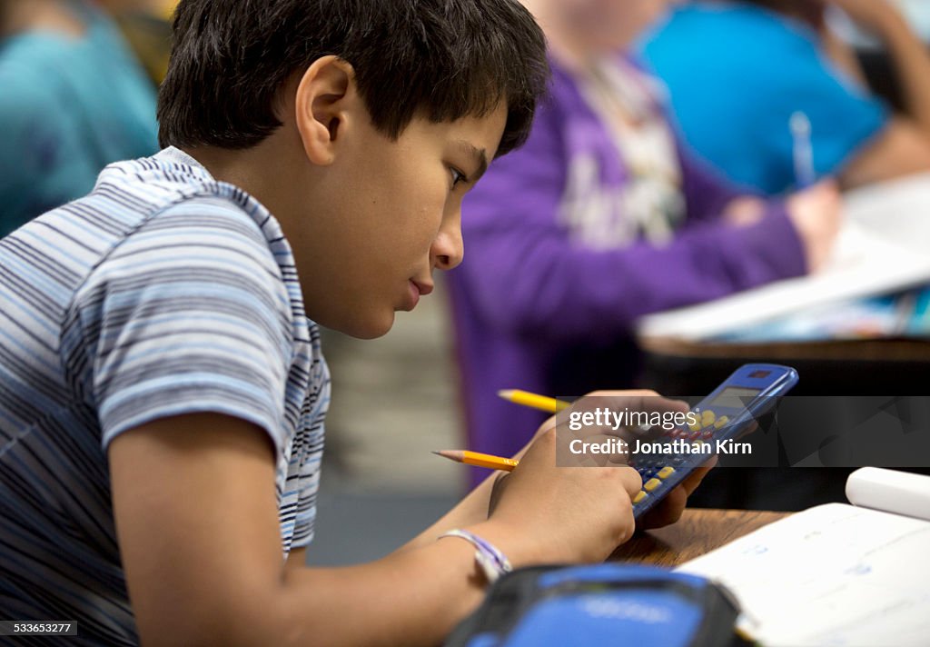 Fifth grade boy in classroom.