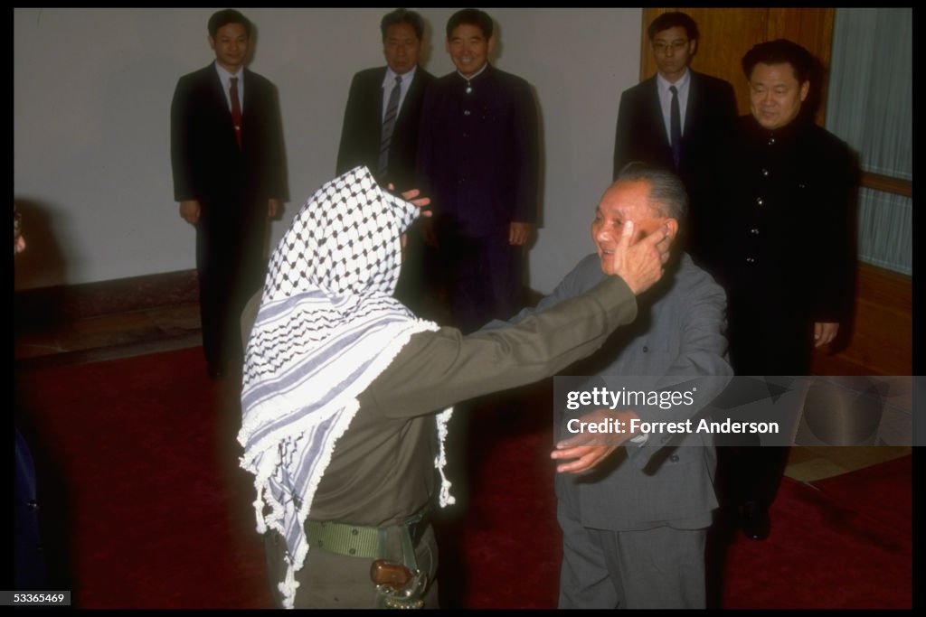 Chmn. Deng Xiaoping, (R), moving to embrace PLO Ch