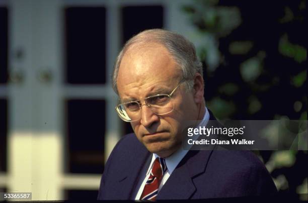 Defense Secretary Dick Cheney poised in WH Rose Garden during Bush announcement of re-appointment of General Colin Powell as chairman of joint chiefs...