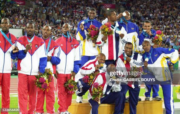 The US 4x100m relay team with Maurice Greene , Brian Lewis , Bernard Williams III and Jonathan Drummond obscured) pose for the media with their...