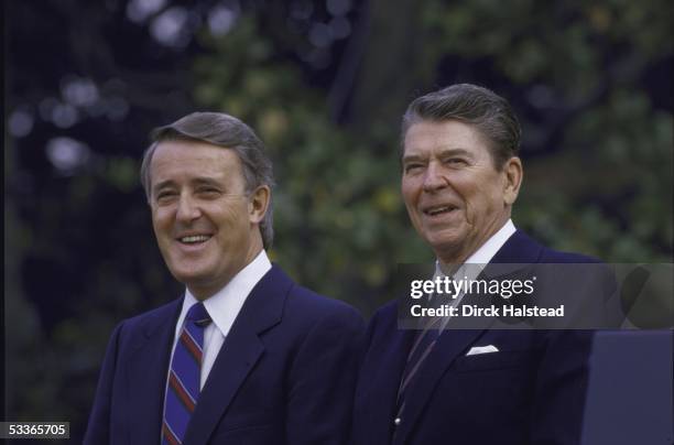 President Ronald with Reagan standing with Canada's Prime Minister Brian Mulroney outside the White House.