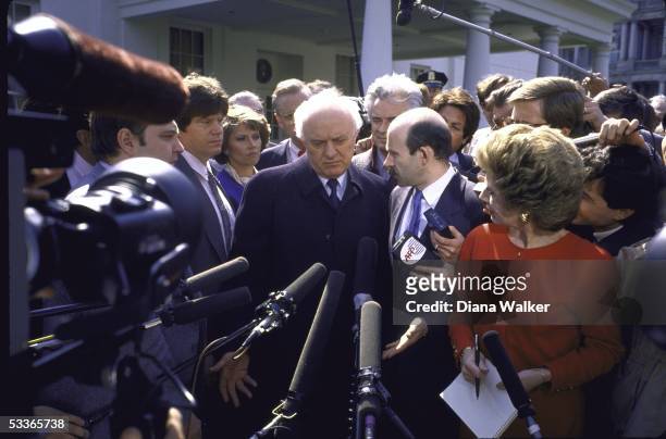Soviet Foreign Minister Eduard A. Shevardnadze with Ambassador Yuri V. Dubinin talking to press outside WH after meeting with President Ronald with...