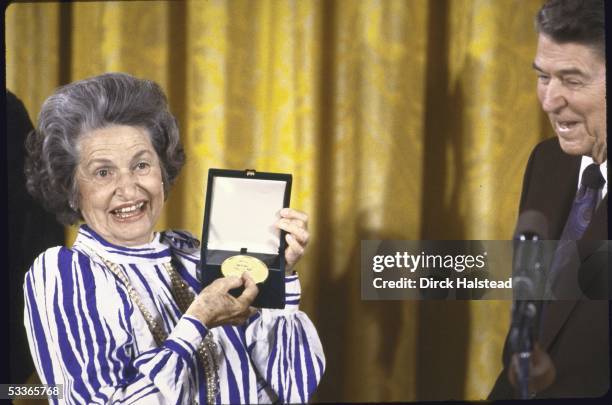 President Ronald with Reagan presenting Congressional Gold Medal to Mrs. Lyndon B. Johnson.