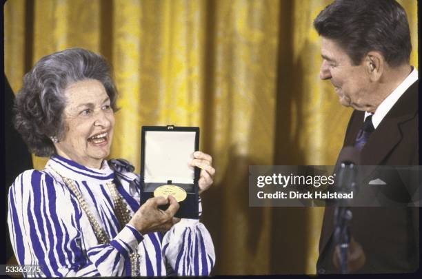 President Ronald with Reagan presenting Congressional Gold Medal to Mrs. Lyndon B. Johnson.