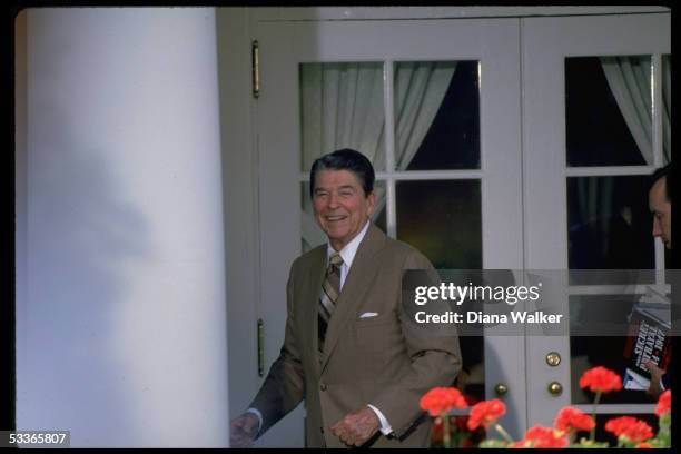 President Reagan poised on WH colonade, answering questions from press on Nicaragua, after Rose Garden ceremony.