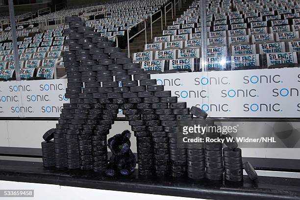 Stuffed black cat placed under hockey pucks sits on top of the San Jose Sharks bench prior to the game against the St. Louis Blues in Game Three of...
