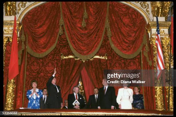 Nancy Reagan, Soviet leader Gorbachev, President Reagan & Raisa Gorbachev standing in ornate flags - adorned box, attending Bolshoi Ballet during...