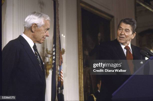 President Reagan with Medal of Freedom winner, arms control adviser Paul Nitze , at awards ceremony.