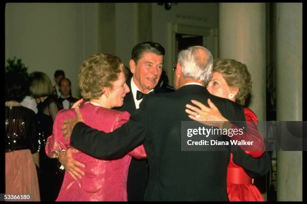 President & Nancy Reagan embracing British PM Margaret & Denis Thatcher during State Dinner.