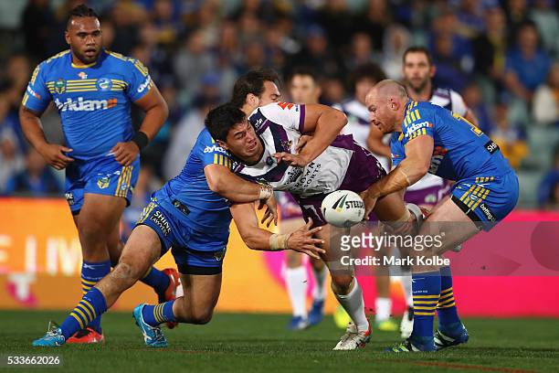 Jordan McLean of the Storm passes as he is tackled during the round 11 NRL match between the Parramatta Eels and the Melbourne Storm at Pirtek...
