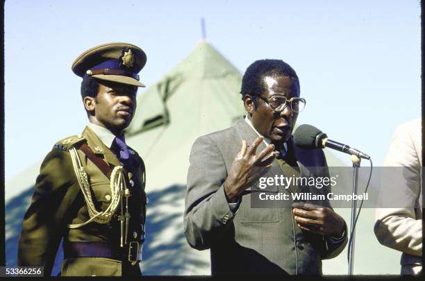 Of Zimbabwe Robert G. Mugabe in military uniform, forcefully gesturing while speaking at election rally at Tsholotsho.