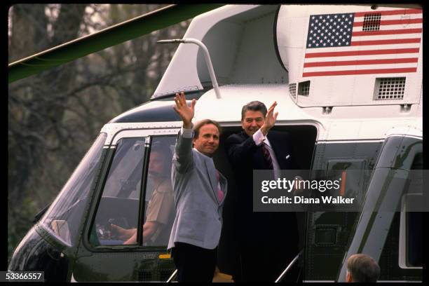 President Ronald Reagan with son Michael Reagan in doorway of Marine One, departing for CA.