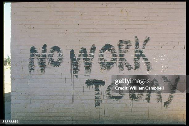 Scrawled on wall during disturbances marking 25th anniv. Of killing of 69 blacks by police.