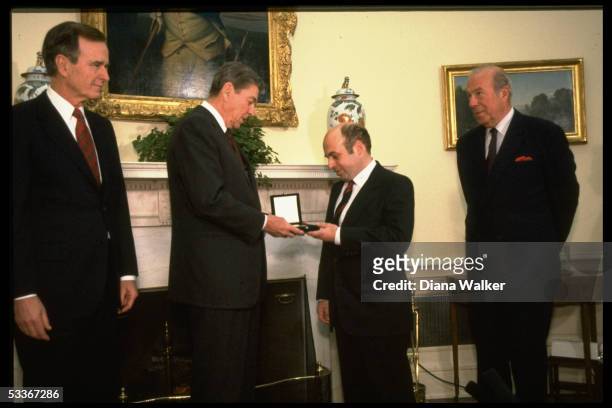 President Reagan presenting Soviet Jewish activist Natan Sharansky with Medal of Honor with VP Bush & State Secretary Shultz .