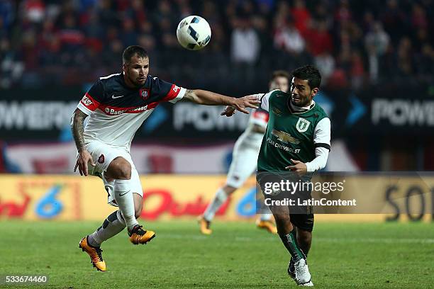 Franco Mussis of San Lorenzo and Walter Erviti of Banfield fight for the ball during a match between San Lorenzo and Banfield as part of Torneo...