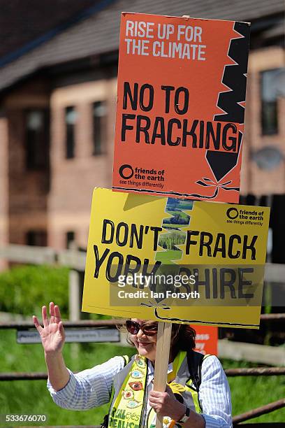 An anti fracking protestor raises support from passing motorists outside the County Hall building in Northallerton as the County council's Planning...