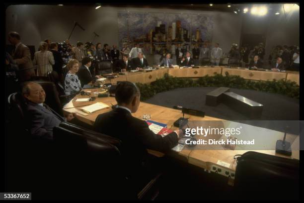 Overall of economic summit plenary session starring President Reagan , British PM Thatcher & PM Mulroney .