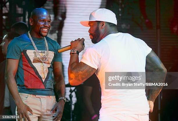 Boxer Floyd Mayweather Jr. Appears onstage with rapper 50 Cent as 50 Cent performs during the official Billboard Music Awards after party at Drai's...