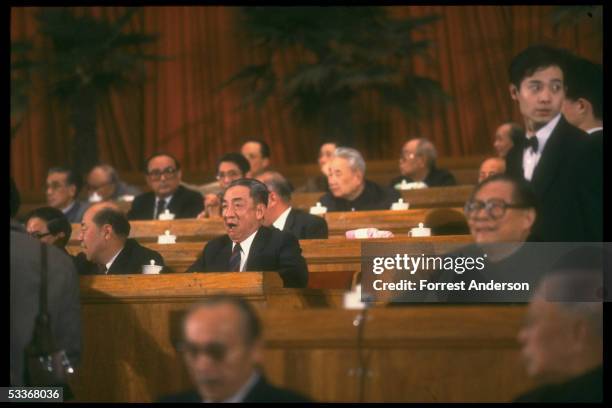 State planning czar Zou Jiahua, newly promoted to Vice-Premier, yawning, seated with Jiang Zemin et al, at closing session of National People's...