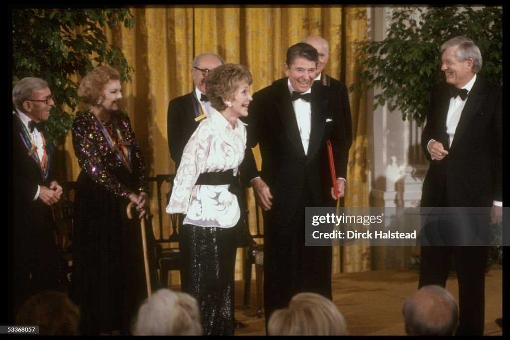 Former Pres. Ronald Reagan (2L) w. award & wife Na