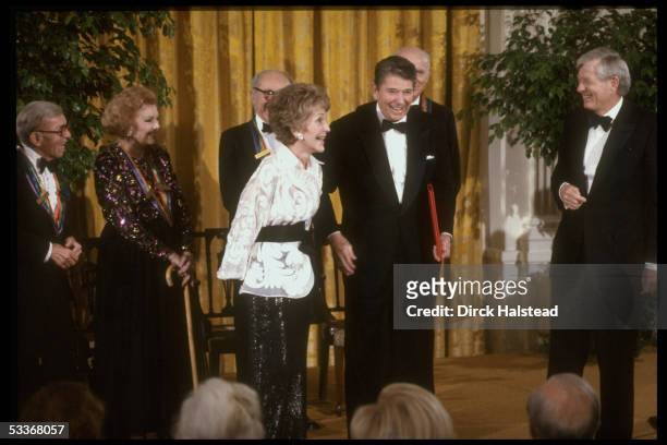Former President Ronald Reagan with award & wife Nancy, R. Davidson & Kennedy Center honorees Myrna Loy , & George Burns .