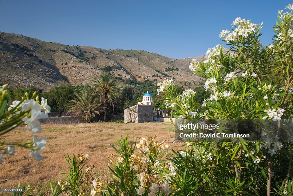 View across field to church, Pedi, Symi, Greece