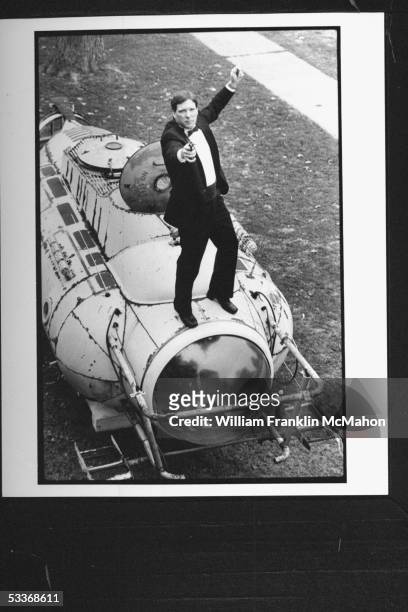 Mailman & leading collector of James Bond memorabilia Doug Redenius in tuxedo standing on top of submarine "Neptune" from film "For Your Eyes Only"...