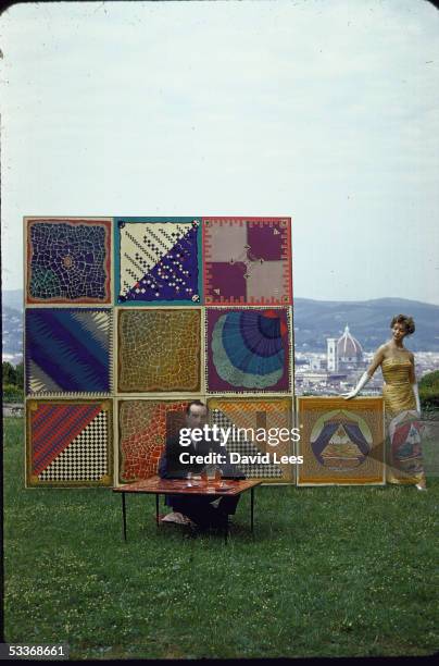 Designer Emilio Pucci sitting on lawn of his palazzo overlooking the city of Florence with table tops and evening dress, his newest creations.
