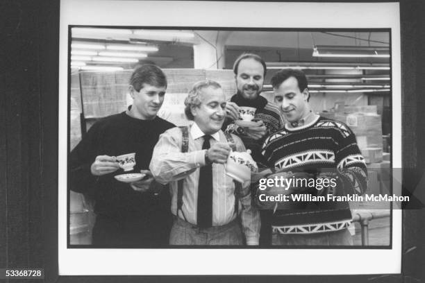 Author Tom Hegg with illustrator Warren Hanson, publisher Ned Waldman & Brett Waldman holding Christmas cups of tea & tea pot at Waldman House Press...