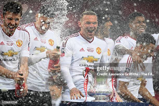 Wayne Rooney of Manchester United leads the team in celebrations after victory in The Emirates FA Cup Final match between Manchester United and...