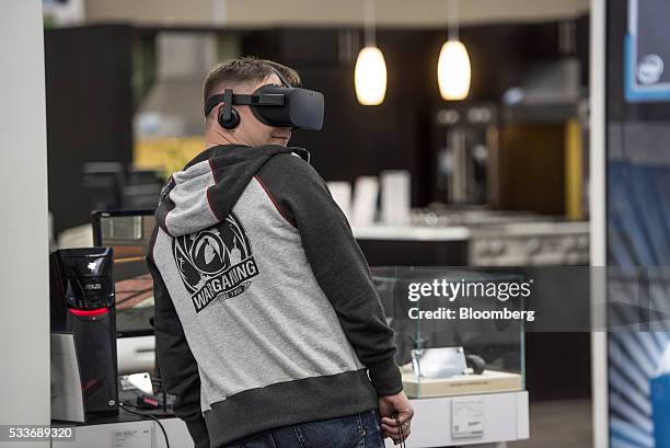 Shopper tries on an Oculus Gear VR Inc. Virtual reality headset at a Best Buy Co. Store in San Francisco, California, U.S., on Thursday, May 19,...