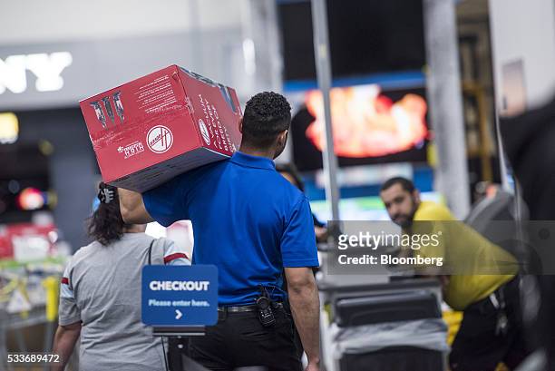An employee carries a Hoover Co. Vacuum box at a Best Buy Co. Store in San Francisco, California, U.S., on Thursday, May 19, 2016. Best Buy Co. Is...