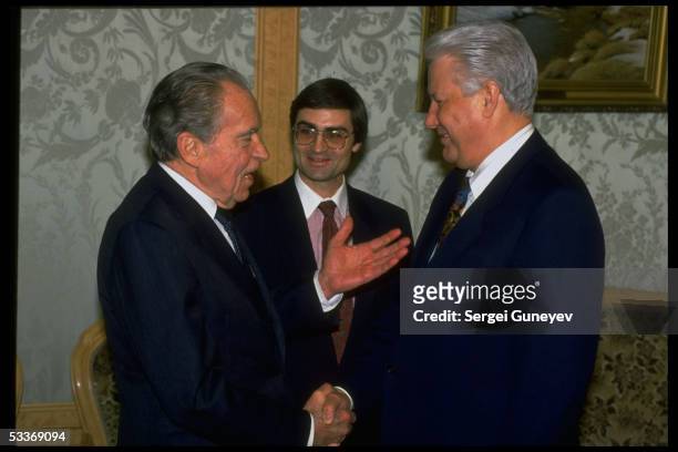 Russian President Boris Yeltsin & former US President Dick Nixon shaking hands, meeting at Kremlin.