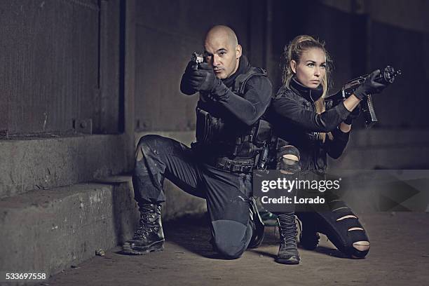 male and female swat team members posing in urban setting - airsoft gun stock pictures, royalty-free photos & images