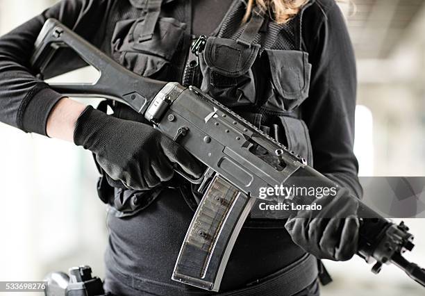 unknown female swat team member posing with rifle - airsoft gun stock pictures, royalty-free photos & images