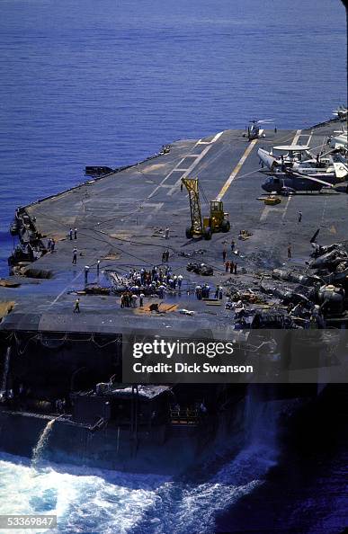 Repair crews working to fix the damaged deck of th Repair crews working to fix the damaged deck of th