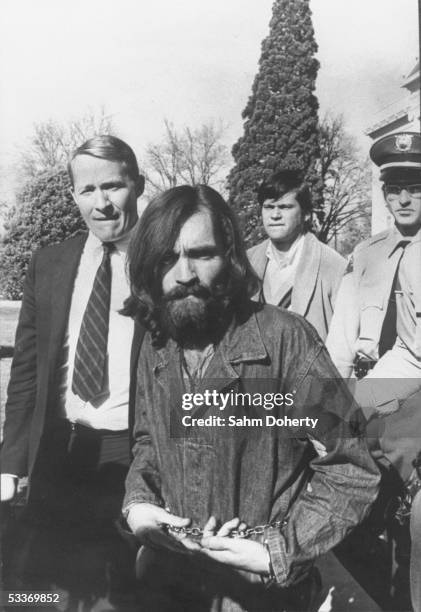 Chained cult leader Charles Manson, whose hippie group is connected with the Sharon Tate murders, being led from a courthouse after a hearing on...