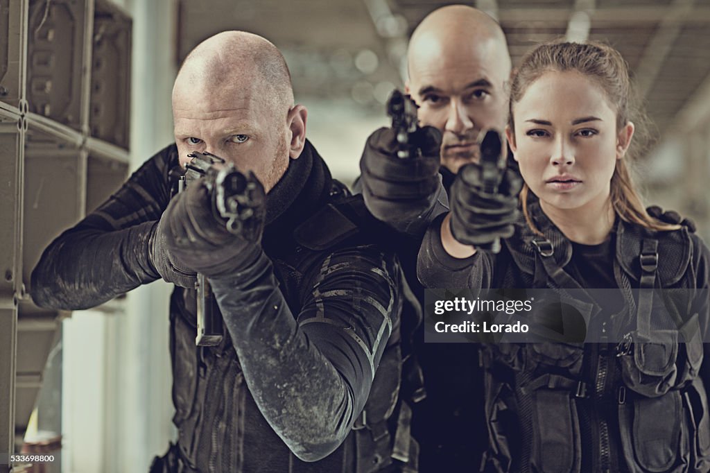 Military swat team members during operation in abandoned warehouse