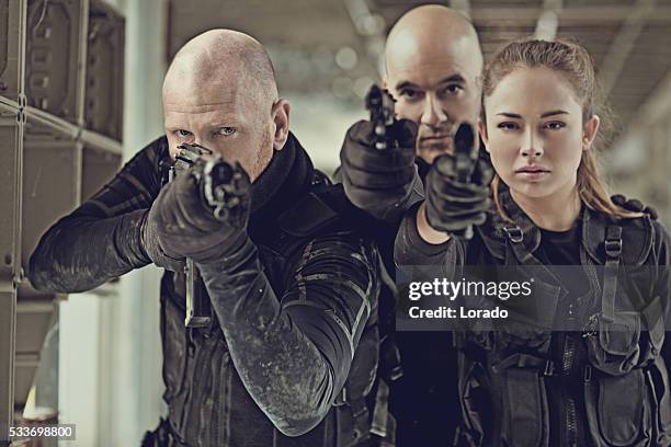 military swat team members during operation in abandoned warehouse - airsoft pistol stock pictures, royalty-free photos & images
