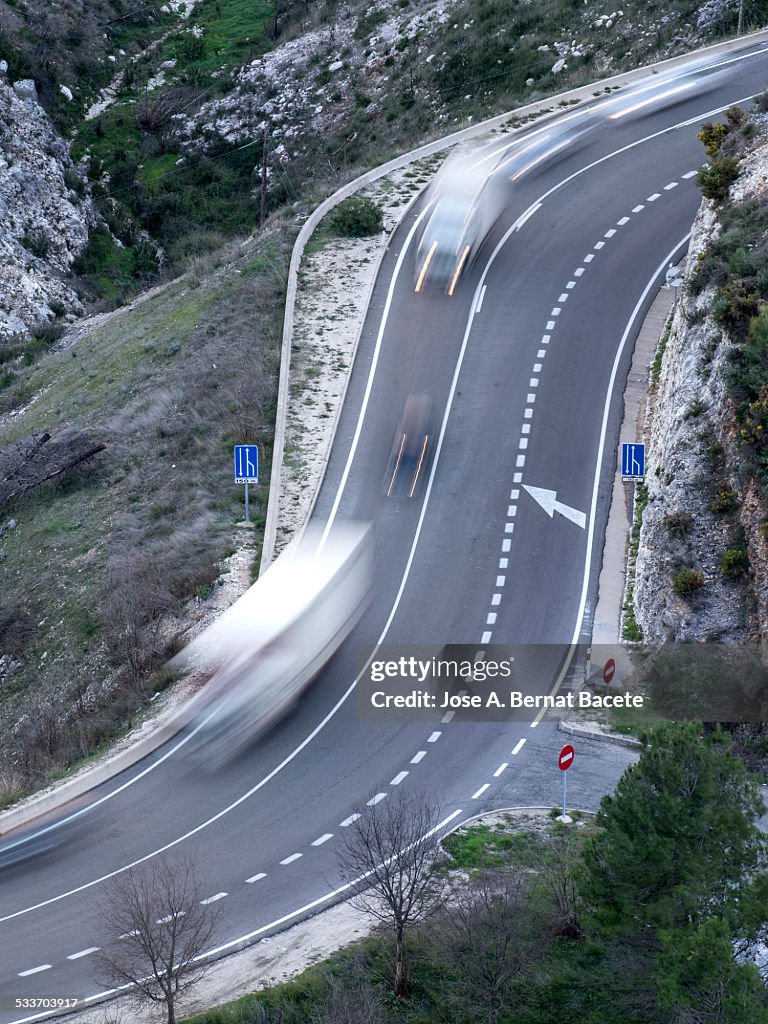 Vehicles in movement in a road with curves