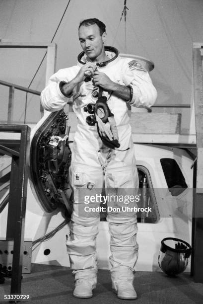 American astronaut Michael Collins putting on his flight suit during final training for the Apollo 11 moon mission.