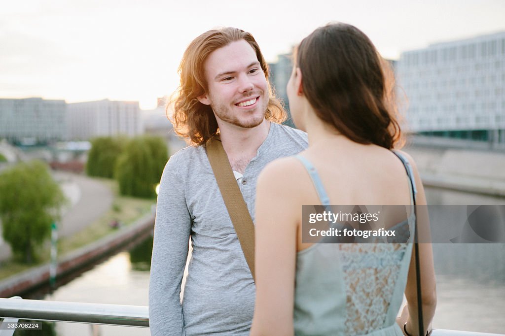 Friendship: two young adult standing together and talking