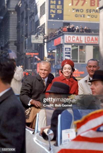 American astronaut John H. Glenn Jr. And his wife Annie ride with American Vice President Lyndon Baines Johnson during a tickertape parade in Glenn's...